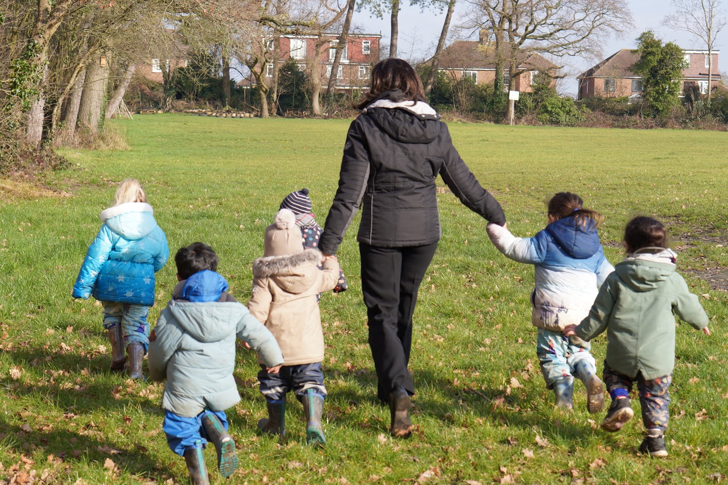 Children playing outdoors in the nursery grounds